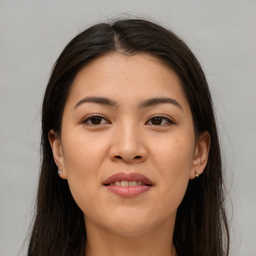 Joyful asian young-adult female with long  brown hair and brown eyes