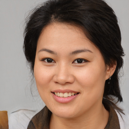 Joyful asian young-adult female with medium  brown hair and brown eyes