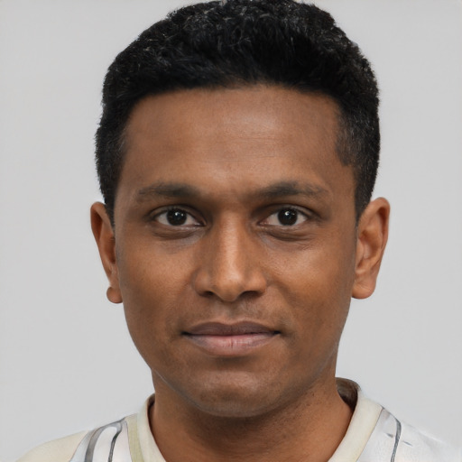 Joyful black young-adult male with short  black hair and brown eyes