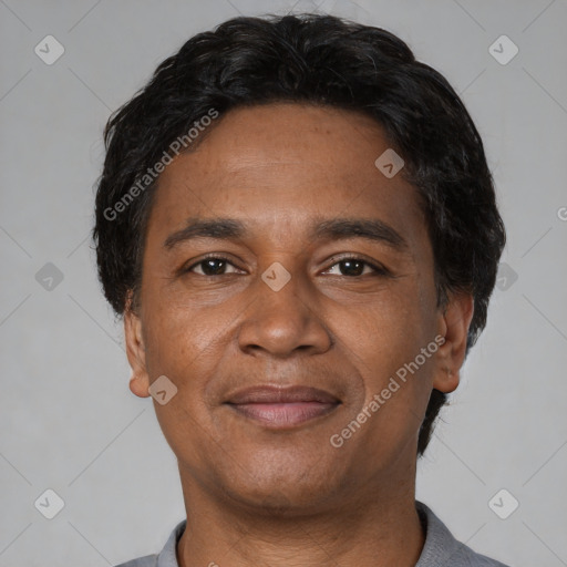 Joyful latino adult male with short  black hair and brown eyes