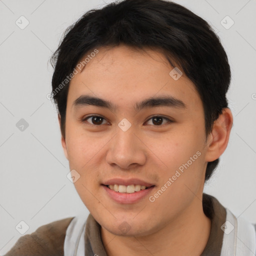 Joyful asian young-adult male with short  brown hair and brown eyes