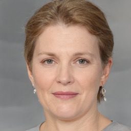 Joyful white adult female with medium  brown hair and grey eyes