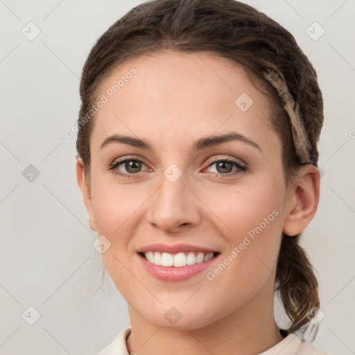 Joyful white young-adult female with medium  brown hair and green eyes