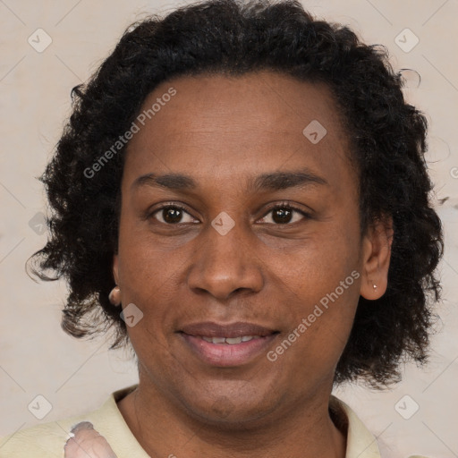 Joyful black adult female with short  brown hair and brown eyes