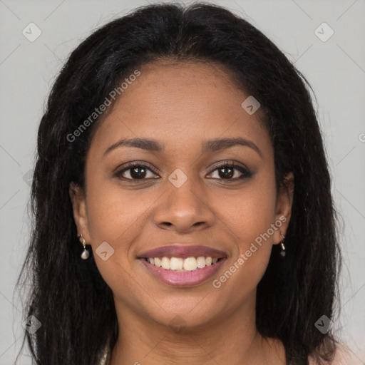 Joyful black young-adult female with long  brown hair and brown eyes