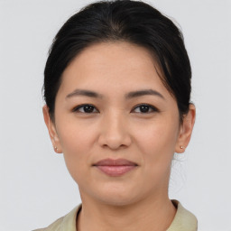 Joyful asian young-adult female with short  brown hair and brown eyes