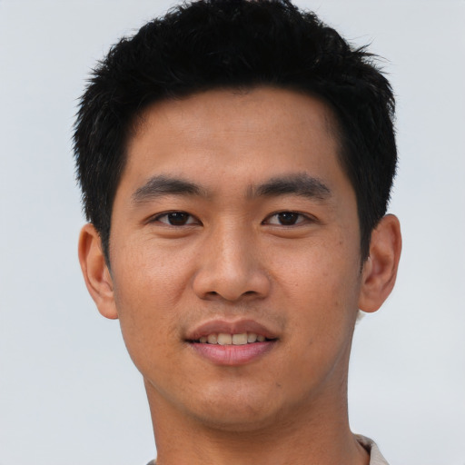 Joyful asian young-adult male with short  black hair and brown eyes