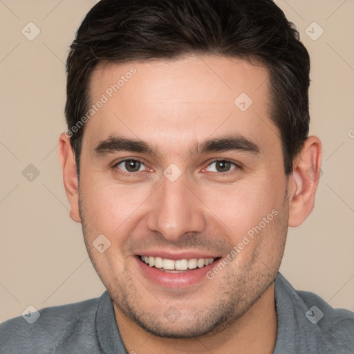 Joyful white young-adult male with short  brown hair and brown eyes