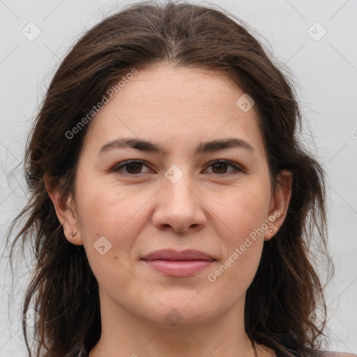 Joyful white adult female with long  brown hair and brown eyes