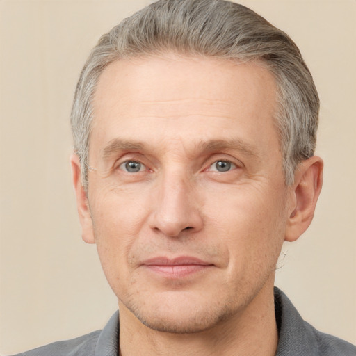 Joyful white adult male with short  brown hair and grey eyes