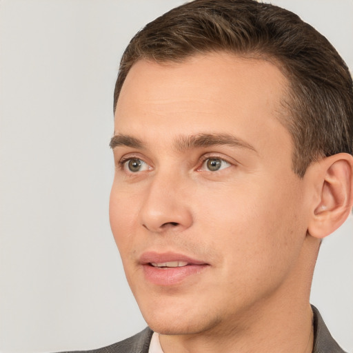 Joyful white adult male with short  brown hair and brown eyes