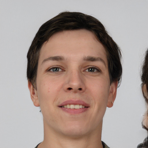 Joyful white young-adult male with short  brown hair and brown eyes