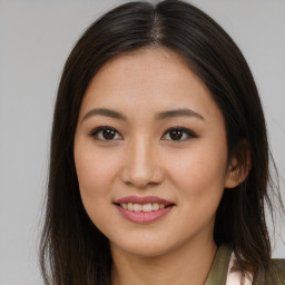 Joyful asian young-adult female with long  brown hair and brown eyes