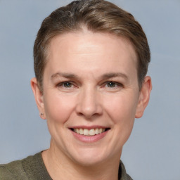 Joyful white adult female with short  brown hair and grey eyes