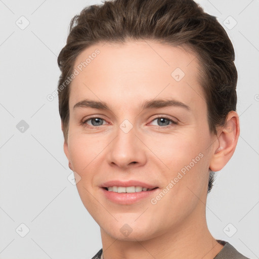 Joyful white young-adult female with short  brown hair and grey eyes