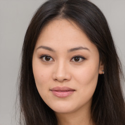 Joyful asian young-adult female with long  brown hair and brown eyes