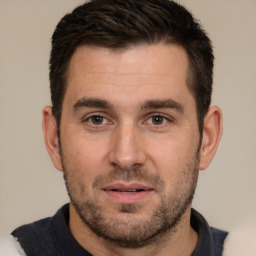 Joyful white adult male with short  brown hair and brown eyes