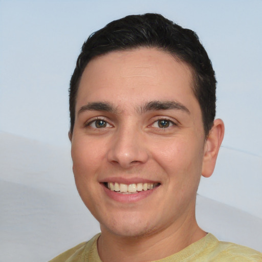 Joyful white young-adult male with short  black hair and brown eyes