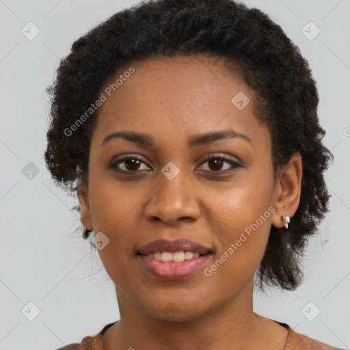 Joyful black young-adult female with long  brown hair and brown eyes