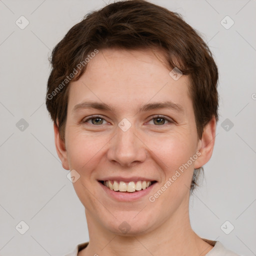 Joyful white young-adult female with short  brown hair and grey eyes