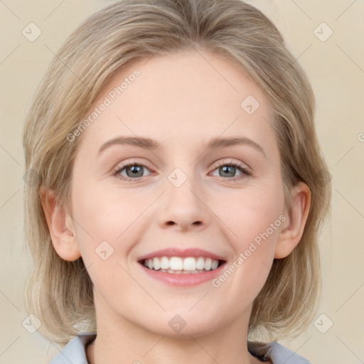 Joyful white young-adult female with medium  brown hair and blue eyes