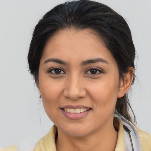 Joyful latino young-adult female with medium  brown hair and brown eyes