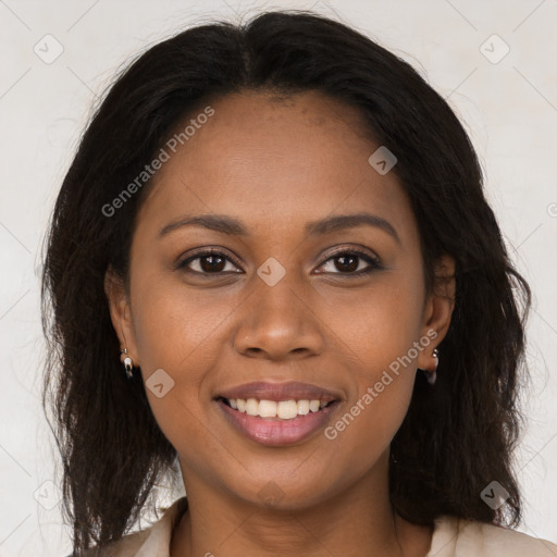 Joyful black young-adult female with long  brown hair and brown eyes