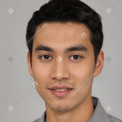 Joyful asian young-adult male with short  black hair and brown eyes