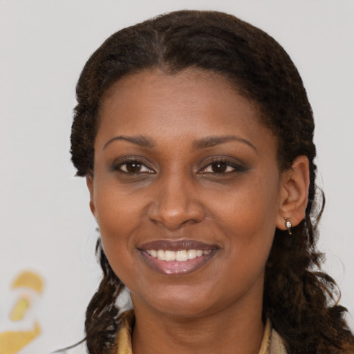 Joyful black young-adult female with medium  brown hair and brown eyes