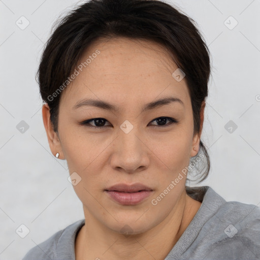 Joyful asian young-adult female with short  brown hair and brown eyes