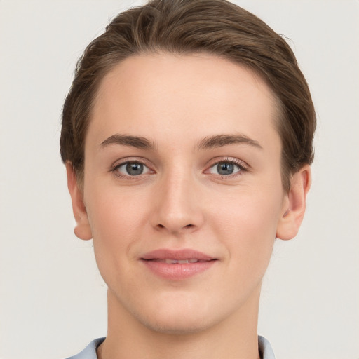 Joyful white young-adult female with short  brown hair and grey eyes