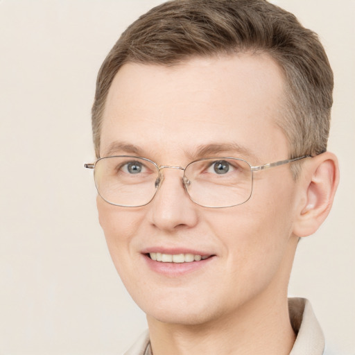 Joyful white adult male with short  brown hair and grey eyes