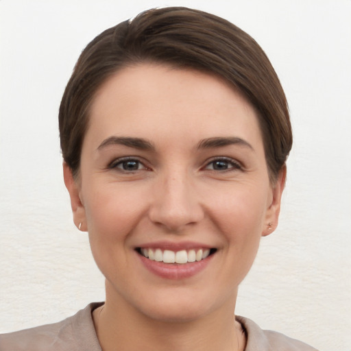 Joyful white young-adult female with short  brown hair and brown eyes