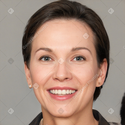 Joyful white adult female with short  brown hair and brown eyes