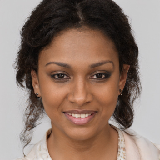 Joyful black young-adult female with medium  brown hair and brown eyes