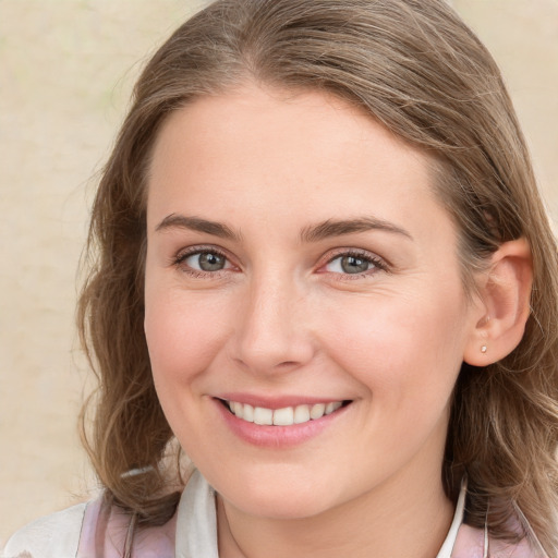 Joyful white young-adult female with medium  brown hair and blue eyes