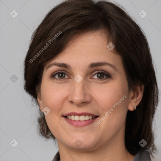 Joyful white adult female with medium  brown hair and brown eyes