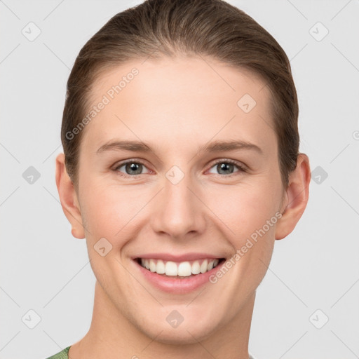 Joyful white young-adult female with short  brown hair and grey eyes