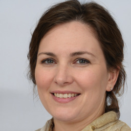 Joyful white adult female with medium  brown hair and brown eyes