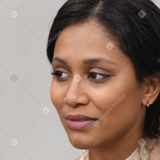 Joyful latino young-adult female with medium  brown hair and brown eyes