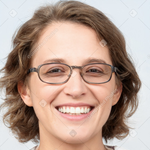 Joyful white adult female with medium  brown hair and blue eyes