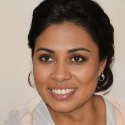 Joyful latino young-adult female with medium  brown hair and brown eyes