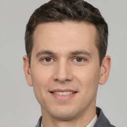 Joyful white young-adult male with short  brown hair and brown eyes