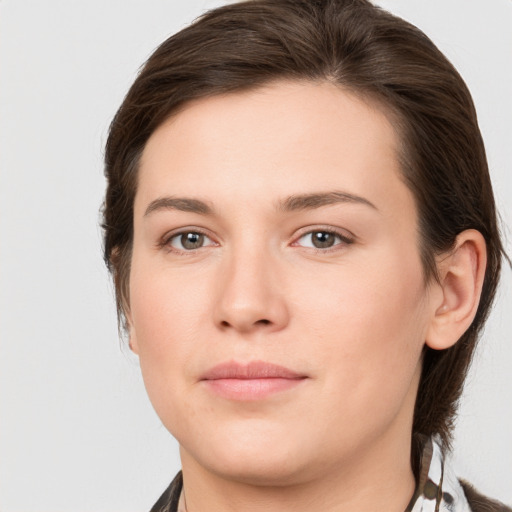 Joyful white young-adult female with medium  brown hair and grey eyes