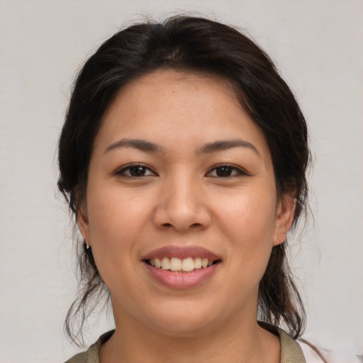 Joyful asian young-adult female with medium  brown hair and brown eyes