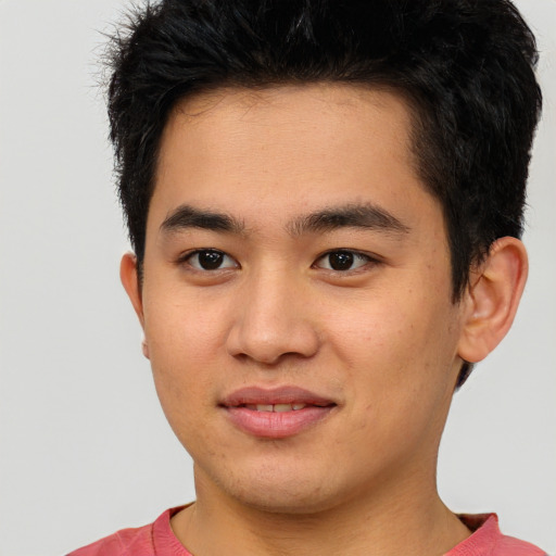 Joyful asian young-adult male with short  brown hair and brown eyes