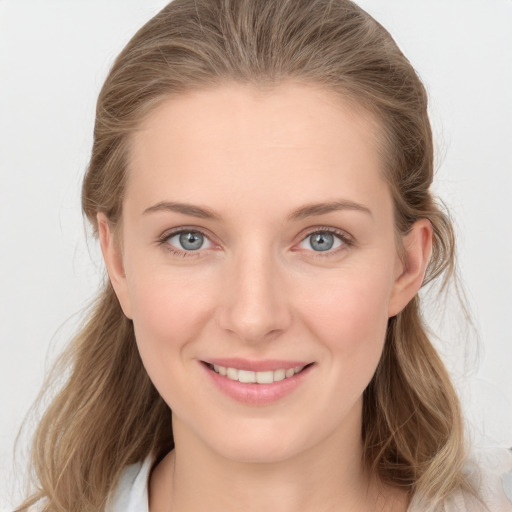 Joyful white young-adult female with long  brown hair and blue eyes