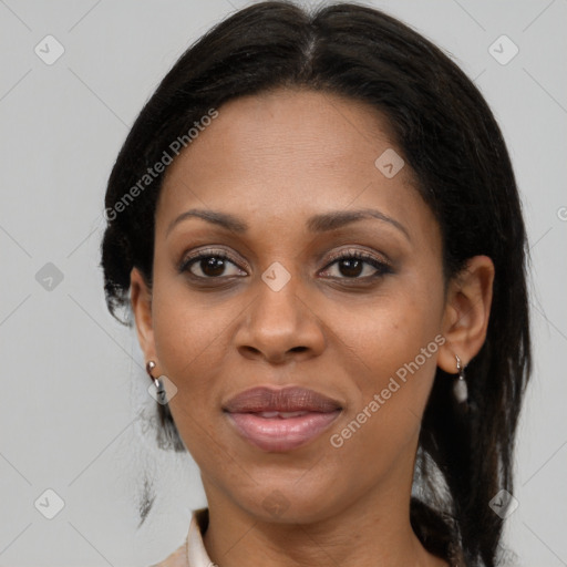 Joyful black adult female with medium  brown hair and brown eyes