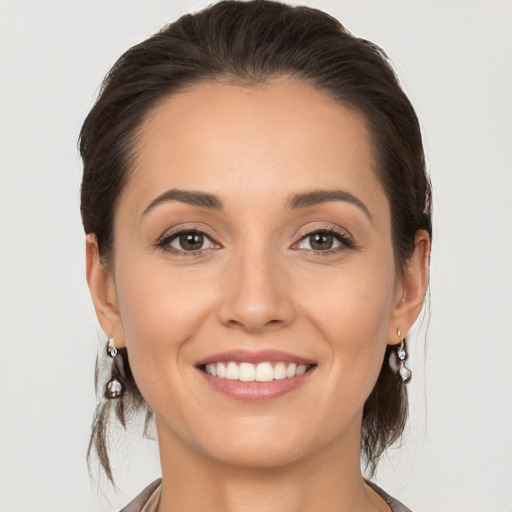 Joyful white young-adult female with medium  brown hair and brown eyes