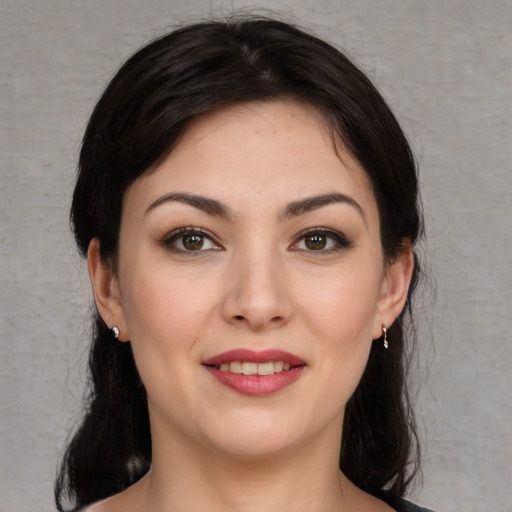 Joyful white young-adult female with medium  brown hair and brown eyes